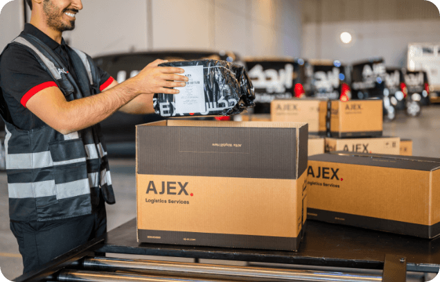 An AJEX employee keeping the items in a AJEX box for delivery
